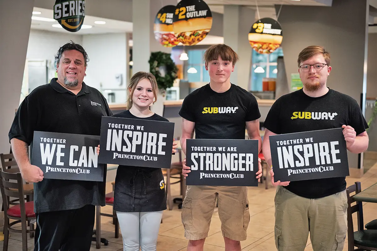 a group of people holding signs with inspirational text